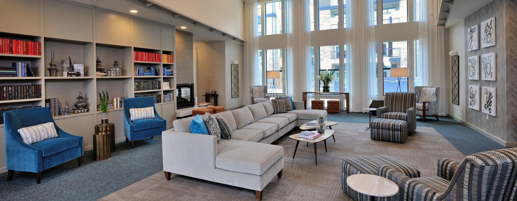 a living room with a large bookcase and a large window